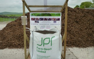 JPR Farm Direct trade stand with large bag of topsoil